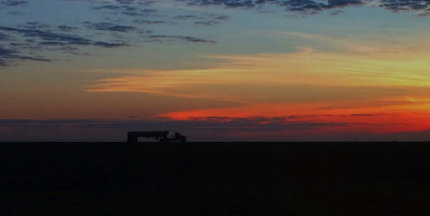 Transit East: photograph of semi at sunrise by Roy Beckemeyer